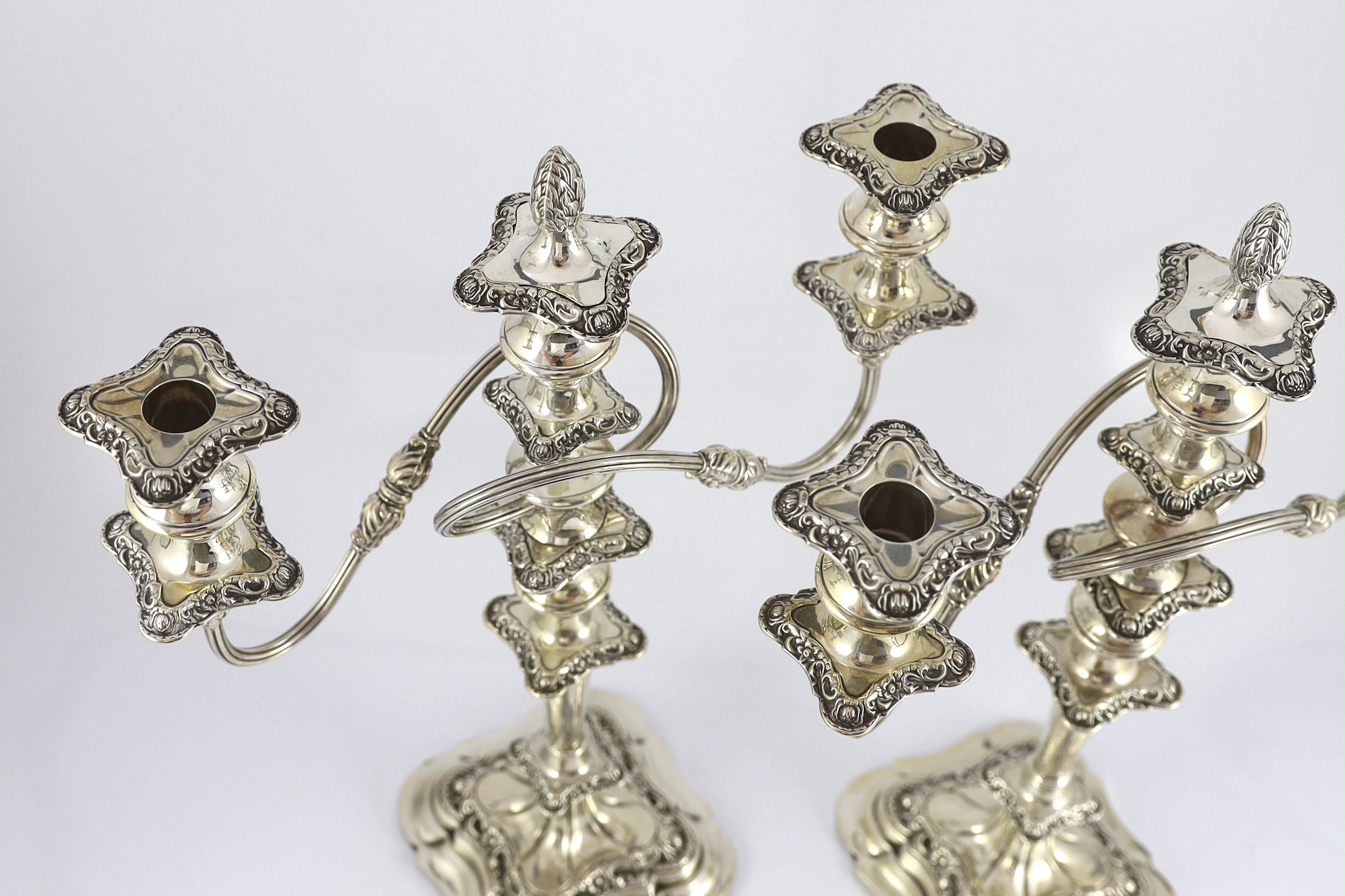 A pair of George VI silver two branch three light candelabra by George Howson